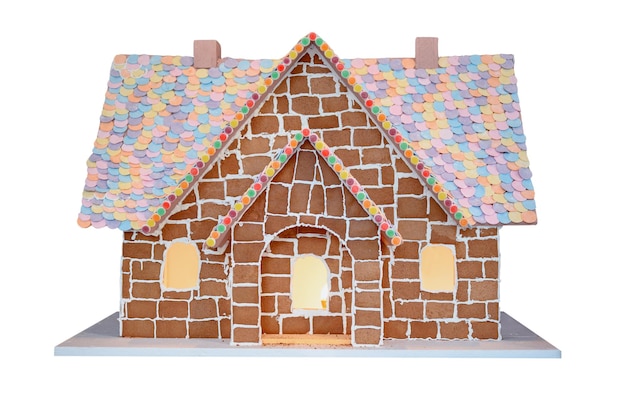 Homemade gingerbread house on Winter season. Merry Christmas and Happy New Year decoration isolated on white background