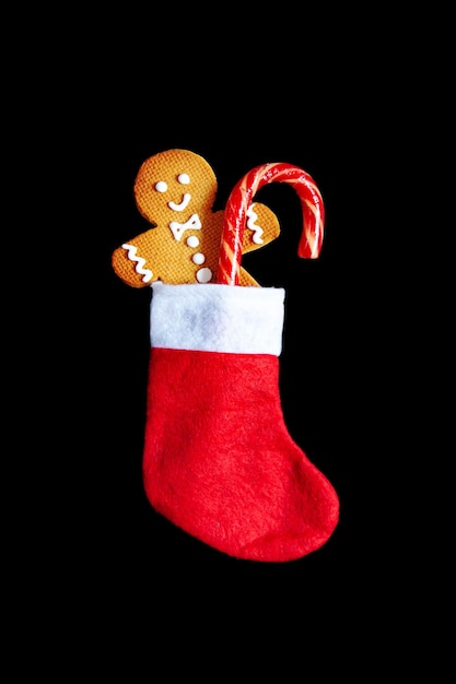 Homemade gingerbread man with a lollipop in a red sock