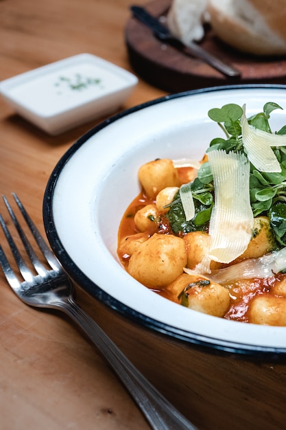 Homemade gnocchi in tomato sauce. Italian food.