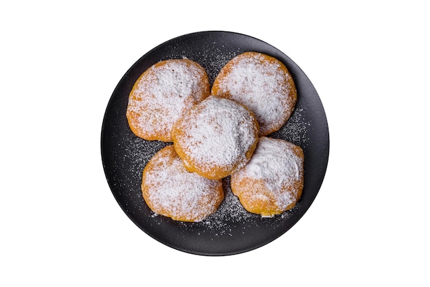 Homemade golden brown corn cookies on a black background