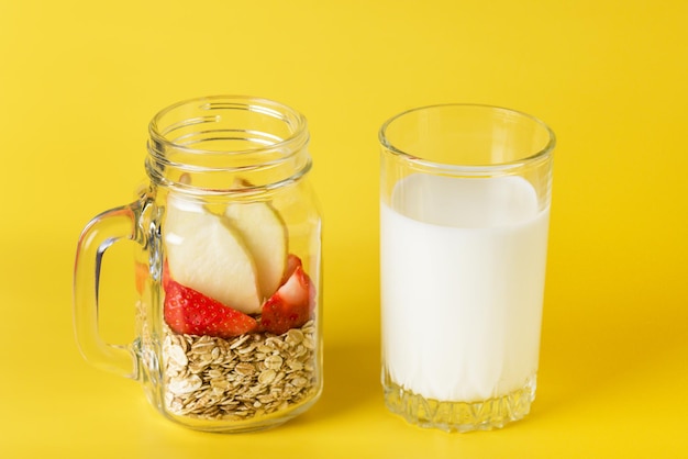 Homemade Granola or Muesli Made of Oats Flake and Honey Cinnamon Apple Strawberry Glass of Milk