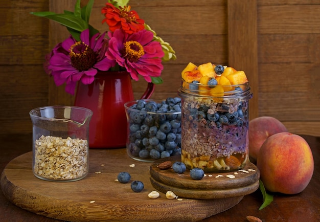 Homemade granola muesli with blueberry and yogurt in glasses on rustic wooden background Healthy breakfast