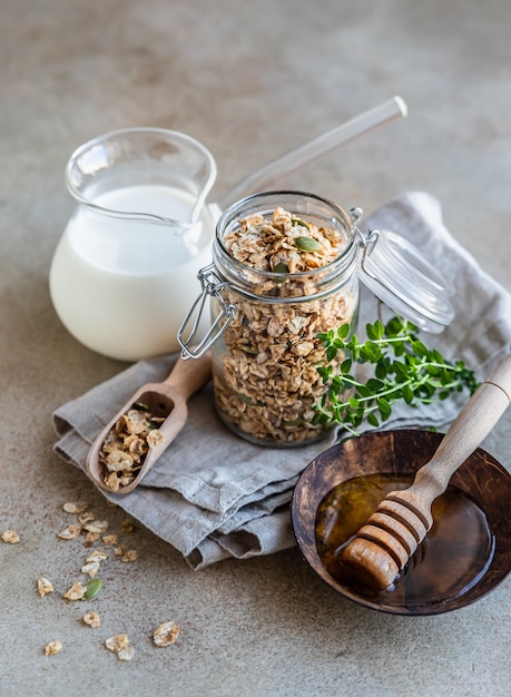 Homemade granola or muesli with pumpkin seeds honey and milk Healthy eating