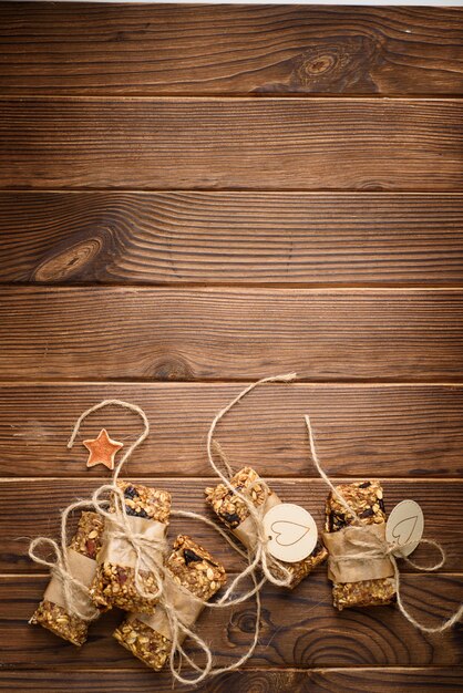 Homemade granola oatmeal energy bars, healthy snack, on wood desk wyth copy space for text