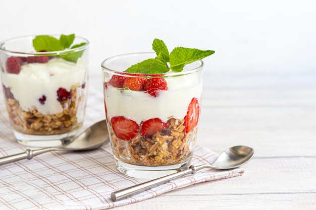 Homemade granola with slices of strawberries and yogurt