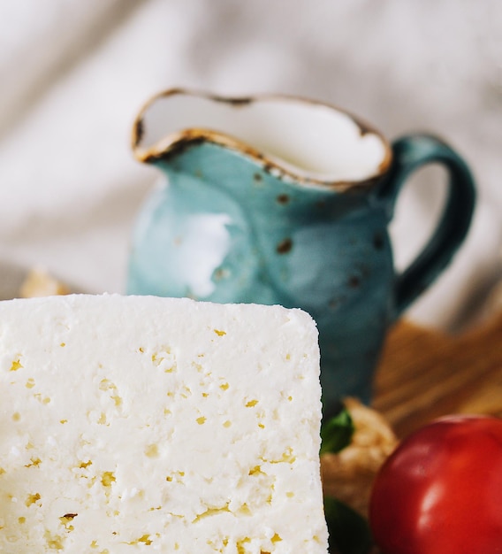 Homemade greek cheese feta on wooden cutting board