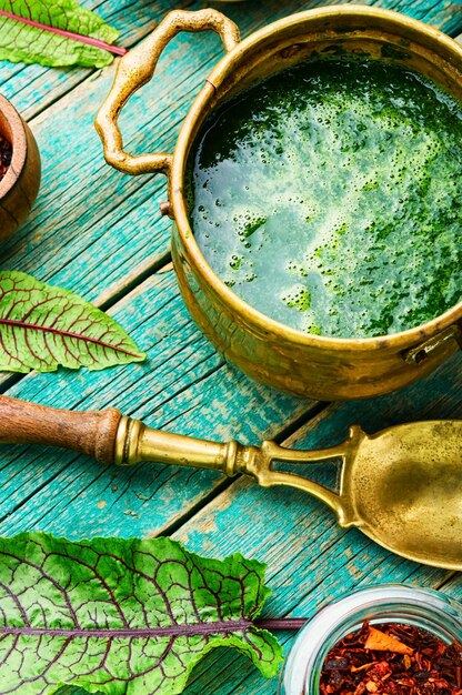 Homemade green sorrel soup.Vegetarian soup in a bowl on rustic wooden background