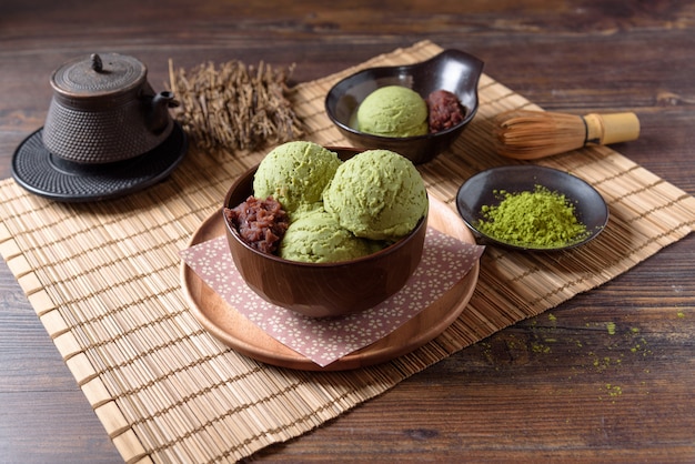 Homemade green tea or matcha ice cream in the wooden bowl and put on bamboo mat