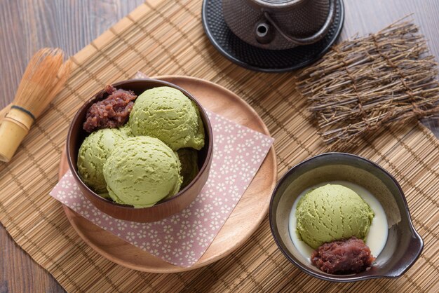 Homemade green tea or matcha ice cream in the wooden bowl and put on bamboo mat