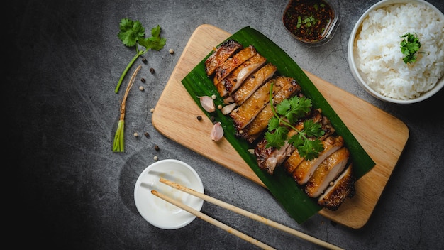 Homemade Grilled chicken fillets on a wood board on the table Horizontal top view from above