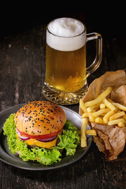 Homemade hamburger with beer and potatoes