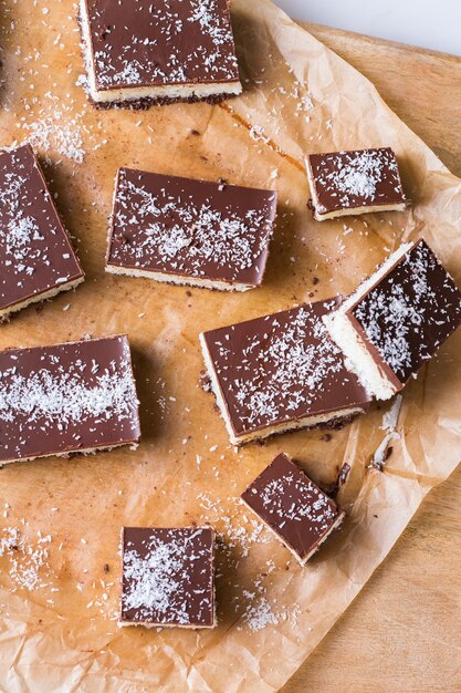 Homemade healthy energy organic raw vegan coconut bars with chocolate on a kitchen table