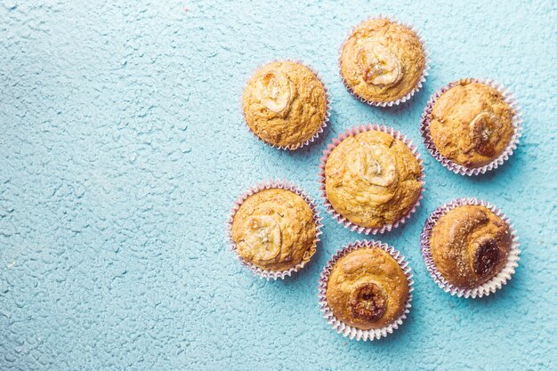 Homemade healthy out banana muffins on blue