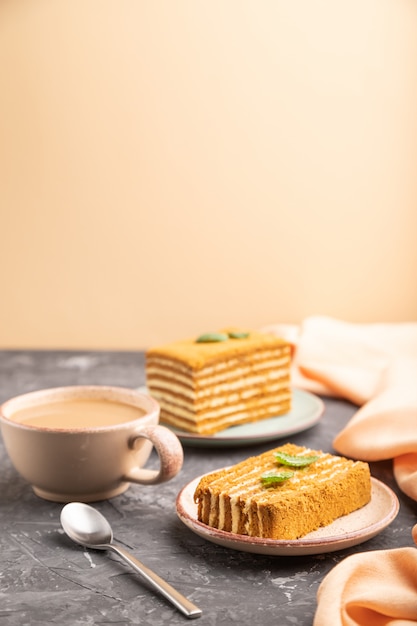 Homemade honey cake with milk cream and mint with cup of coffee