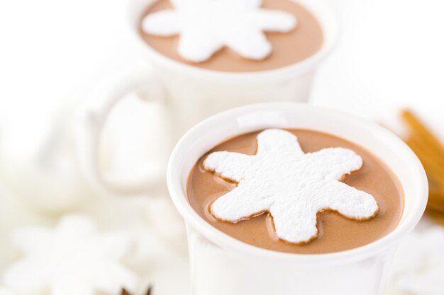 Homemade hot chocolate garnished with snowflake shaped white marshmallows.