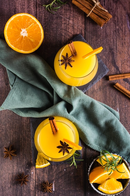 Homemade hot orange grog with cardamom and cinnamon in glasses on the table Top and vertical view