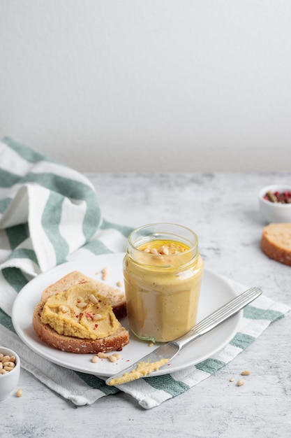 Homemade hummus with pine nuts and bread