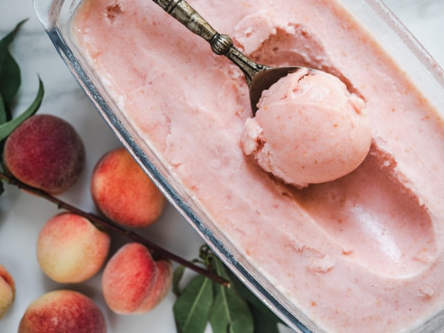 Homemade ice cream and ripe juicy peaches