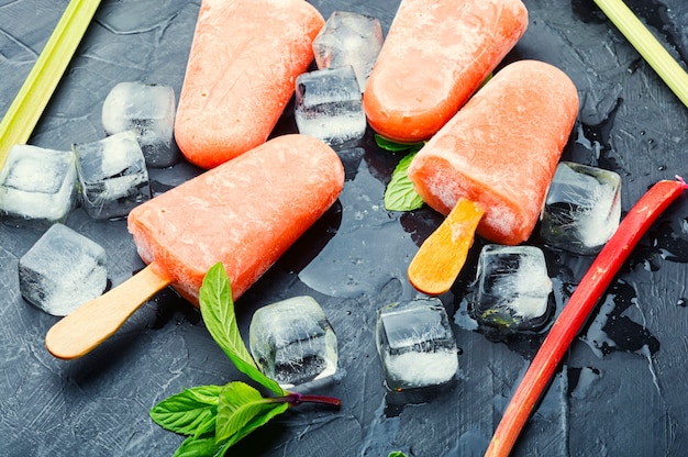 Homemade ice cream with rhubarb and mint.Ice cream on stick and ice