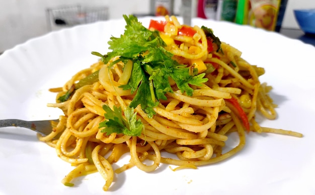 Homemade IndoChinese recipe Schezwan Noodles or vegetable Hakka Noodles or chow mein selective focus