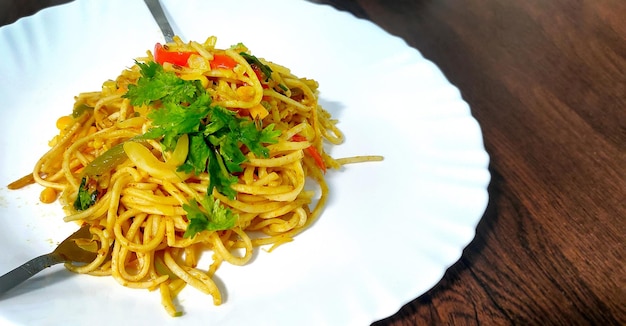 Homemade IndoChinese recipe Schezwan Noodles or vegetable Hakka Noodles or chow mein selective focus