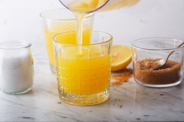 Homemade Isotonic Energy Drink and Ingredients. Glasses With Yellow Liquid, Homemade Sport Beverage, horizontal orientation