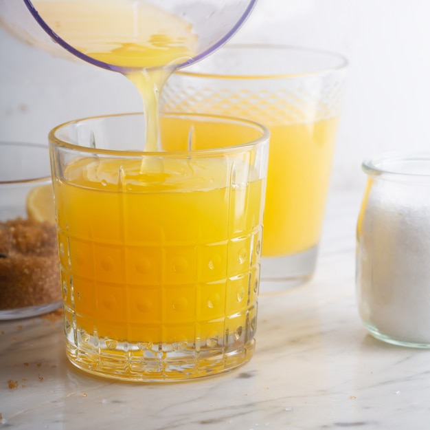 Homemade Isotonic Energy Drink and Ingredients. Glasses With Yellow Liquid, Homemade Sport Beverage