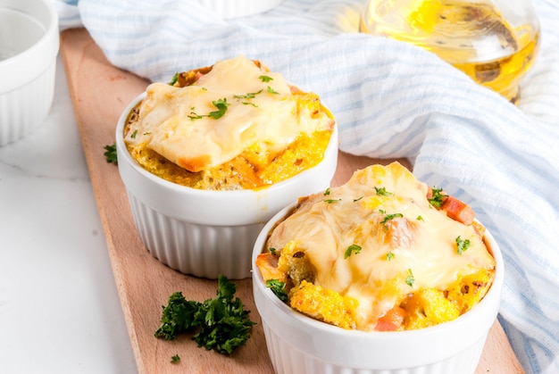 Homemade italian bread casserole strata with cheese, egg and ham, white surface copy space