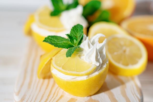 Homemade italian lemon sorbet decorated with mint. Homemade icecream in lemon decorated with mint. Sorbetto al limone.