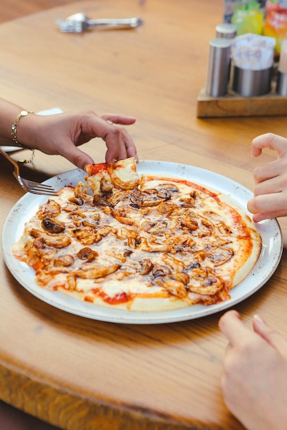 モッツァレラチーズサラミトマトソースペッパールッコラとスパイスを使った自家製イタリアンピザ