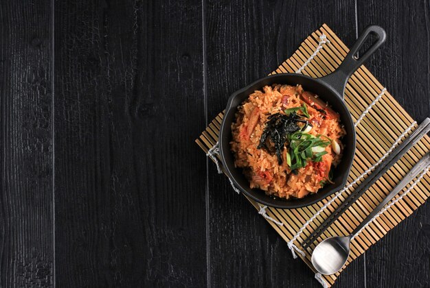 Homemade Kimchi Fried Rice Topped with Fried Egg on Skillet, Overhead View