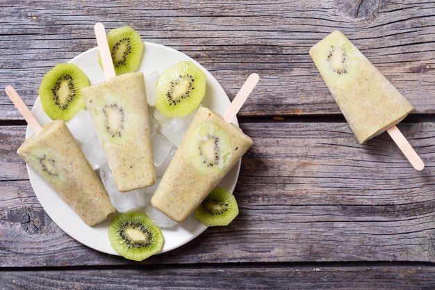 Homemade kiwi popsicle withe ice top view