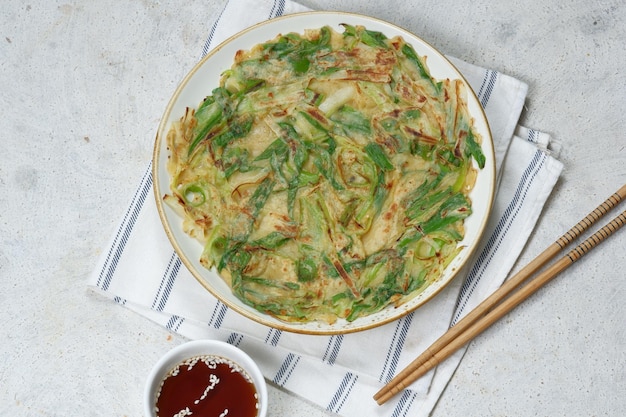 Homemade korean pajeon scallion pancake or korean pancake with\
dipping sauce