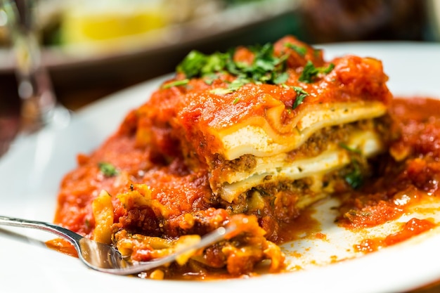 Homemade Lasagna on the table in Italian restaurant.