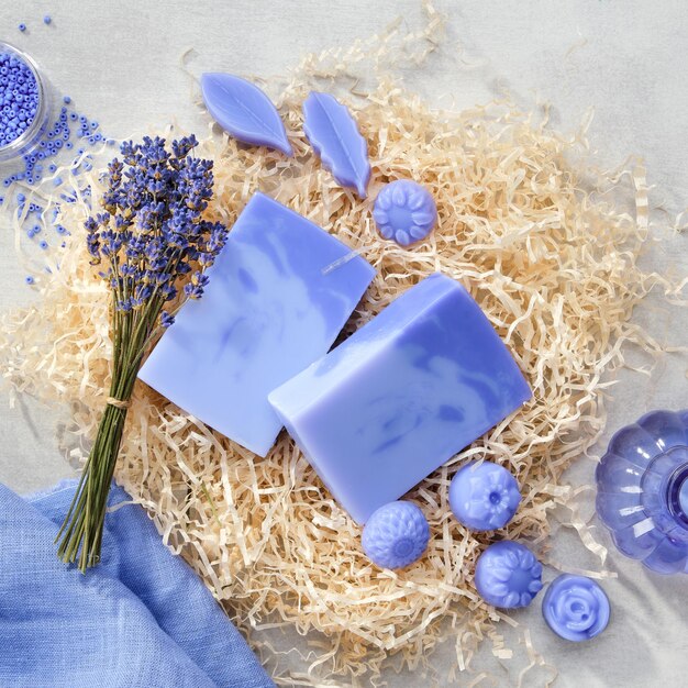 Homemade lavender soap bars and candy shaped soap lavender extract bottle and dry lavender flowers