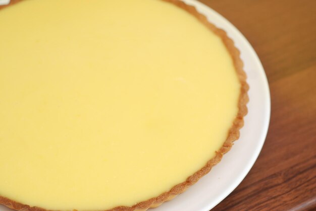 Homemade Lemon Cheesecake Pie on Yellow Background. Food Preparing.