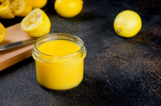 Homemade Lemon Kurd in a glass jar with spoon