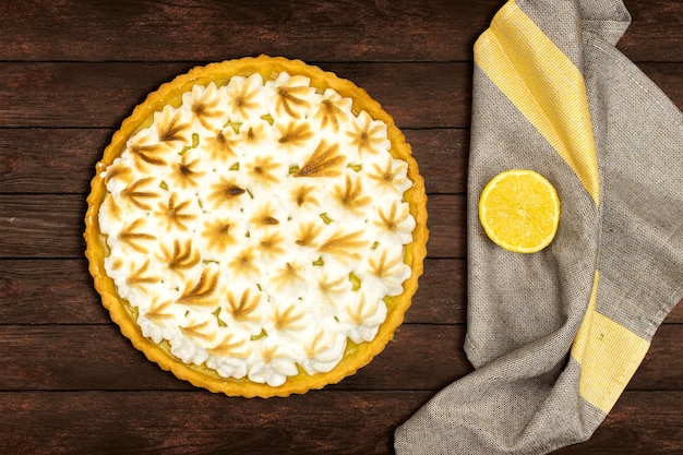 homemade lemon meringue pie with lemon fruit on wooden background