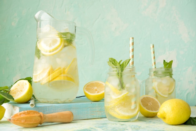 Homemade lemonade with lemons on a rustic space