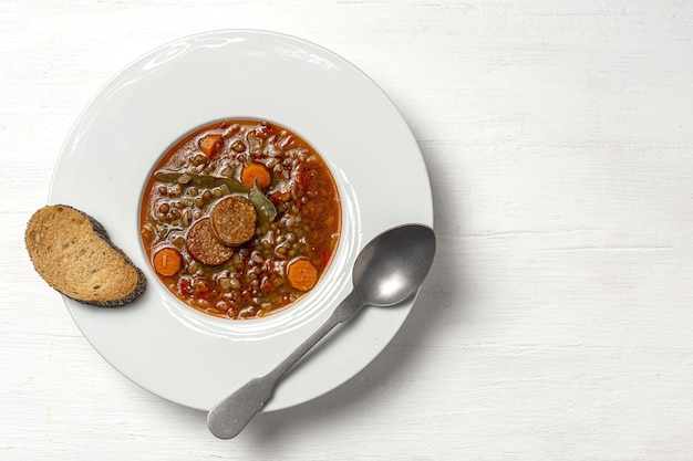 Homemade lentil stew with vegetables and chorizo