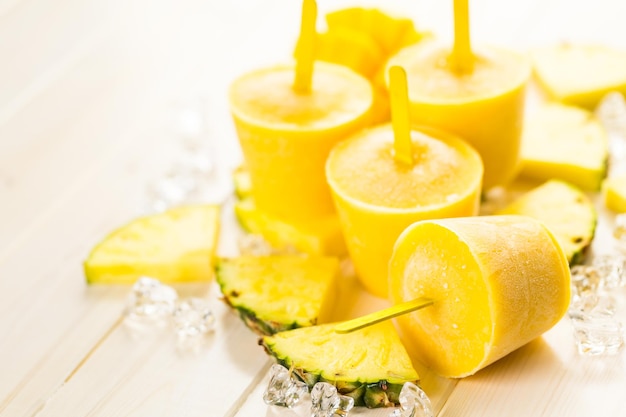 Homemade low calorie popsicles made with mando, pineapple and cocconut milk.