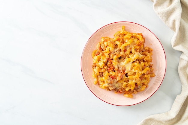 Homemade macaroni bolognese with cheese