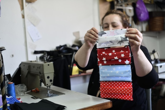 Homemade Manufacturing Of Protective Trendy Medical Face Mask. Tailor Woman Sewing With Machine At Home, Healthcare New Normal Concept In Coronavirus Covid19 Lockdown