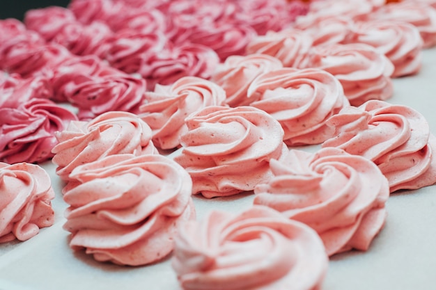 Homemade marshmallows pink on a white parchment