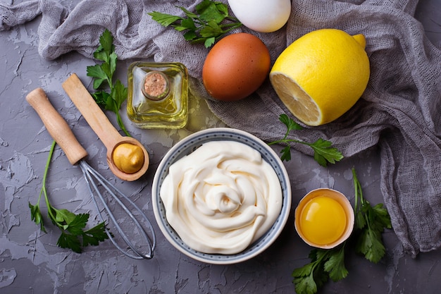 Homemade mayonnaise sauce and olive oil, eggs, mustard, lemon. Selective focus