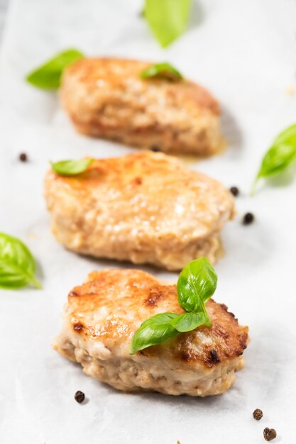 Homemade meat cutlets with basil leaves