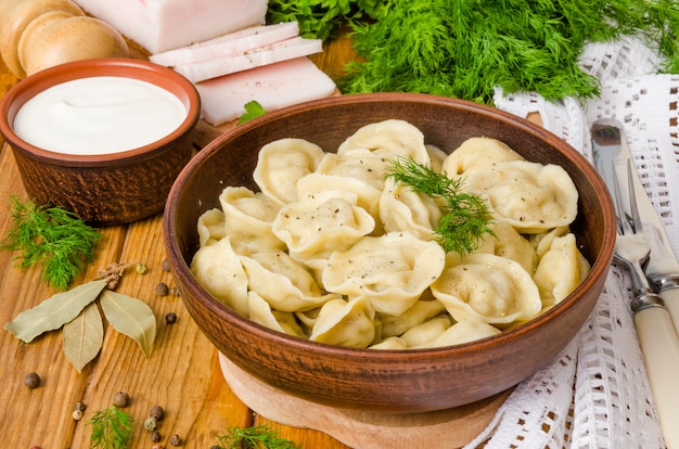 Homemade Meat Dumplings - russian pelmeni. Traditional Russian dish. Rustic style.