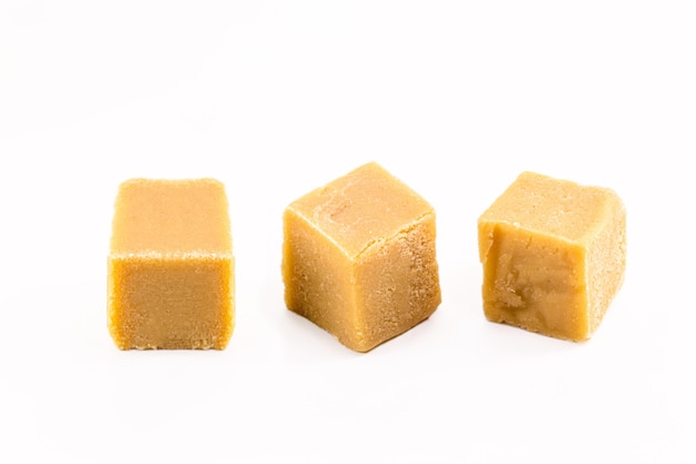 Homemade milk sweet cubes made in Brazil with condensed milk, isolated white background.