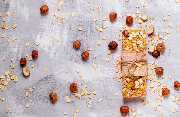 Homemade muesli bar with hazelnuts oat flakes and honey flat lay