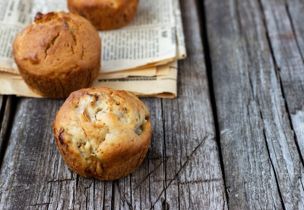 Homemade muffins with apple on a wooden table